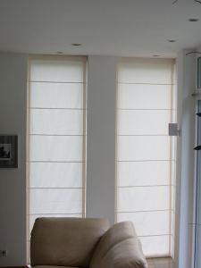 The same type of Roman blinds covering the narrower (fixed) east-facing windows.